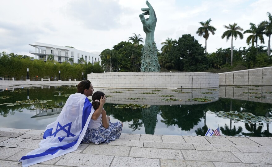 Elinor Ben David (left) hugs her daughter Liel Abissidan, 8, as they wait for a rally in support of Israel to start, at the Holocaust Memorial Miami Beach on Oct. 10, 2023, in Miami Beach, Fla.