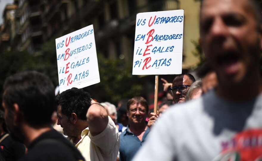 Spanish law does not currently prohibit Uber and other private taxi apps or ride-sharing schemes. But Spain's taxi unions are lobbying politicians to intervene and protect their industry. Here, another scene from the July 1 protests.