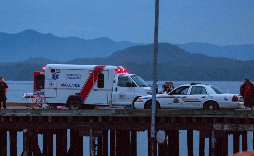 Rescue personnel, mounting a search for victims of a capsized whale-watching boat, park on a wharf in Tofino, British Columbia, on Sunday.