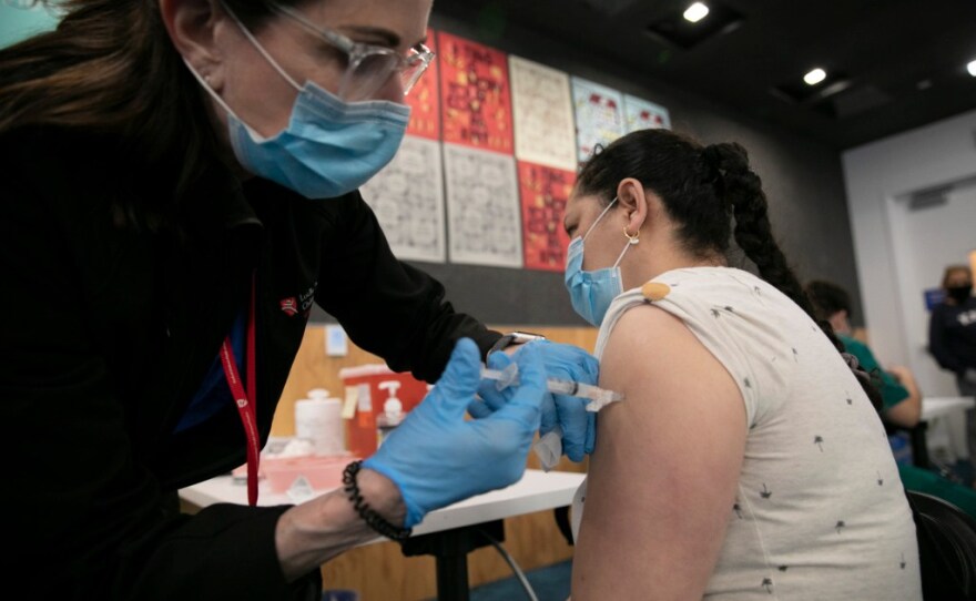 An East Palo Alto resident is inoculated during a COVID-19 vaccination clinic run by Ravenswood Family Health Network at Facebook headquarters in Menlo Park on April 10, 2021. Ravenswood clinics serve low-income populations with more than half of their patients participating in Medi-Cal and other public health care programs.