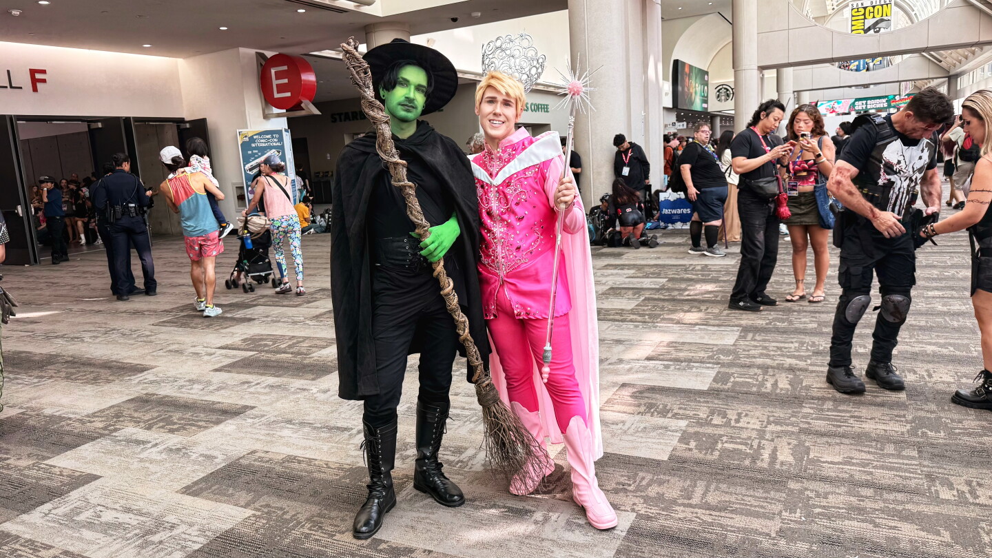 Two fans embrace the magic of "Wicked" with cosplay inspired by Elphaba and Glinda at Comic-Con on July 26, 2026.
