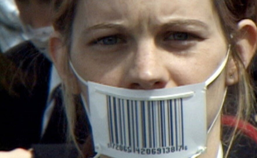 Film still of girl with barcode mask.