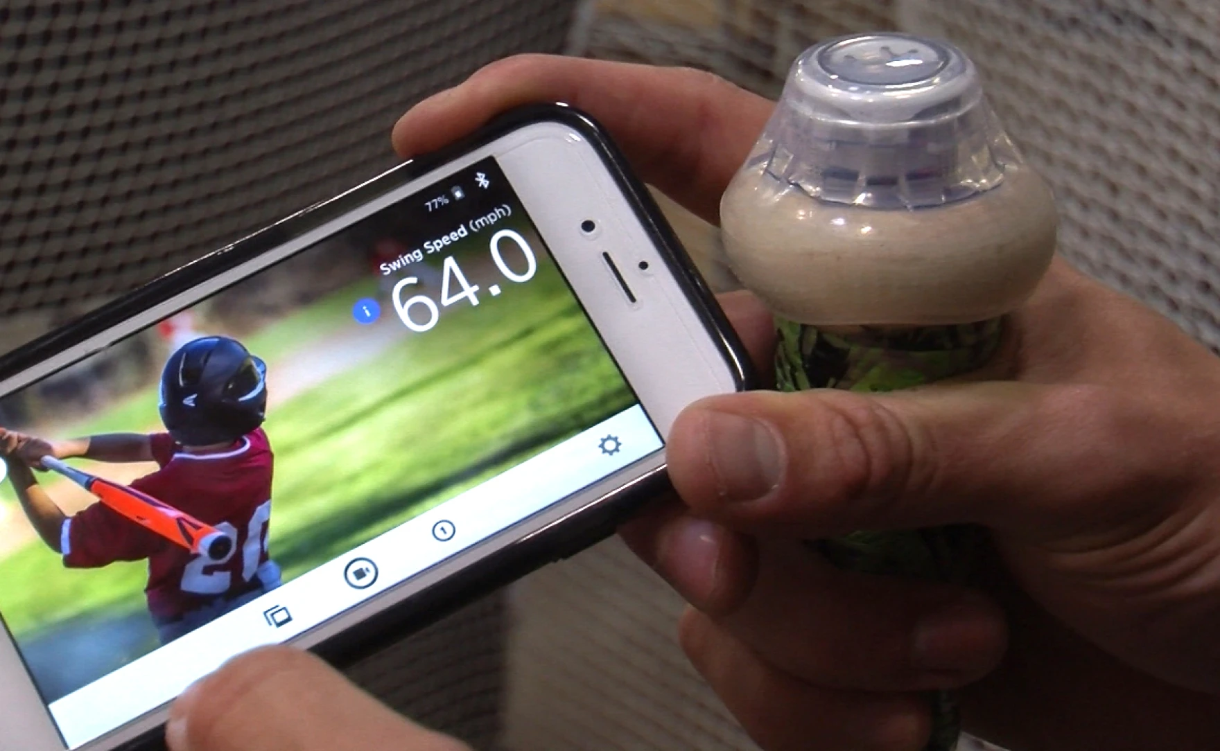 Blast Motion's swing analyzer (right) is synced via bluetooth to a phone providing real-time metrics, June 1, 2016.