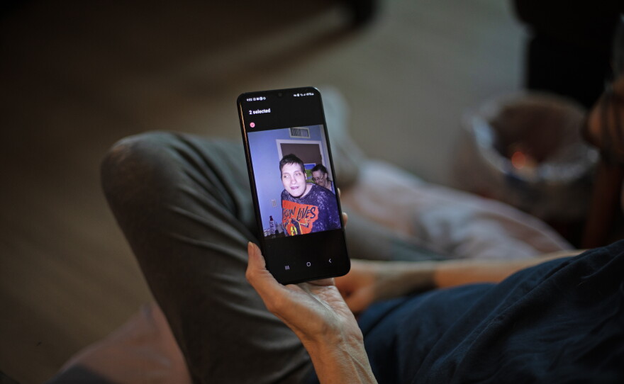 Debbie Willson holds a photo of her son, Adam Willson, who died in June 2024. Debbie is sure his death was influenced by heat, but his death certificate doesn't mention it. Such omissions are common nationwide and result in an undercount of the impact of heat, an investigation from NPR and Boston University finds.