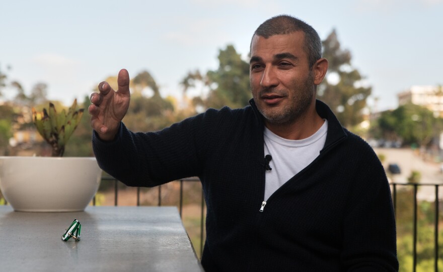 Soheil Nakhshab talks outside his home