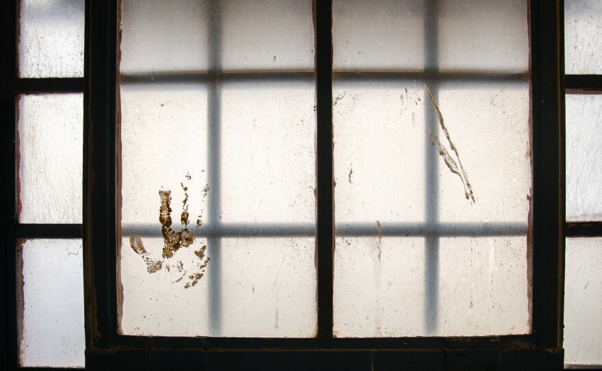 A handprint stained on the window at the Navajo Nation Detention in Shiprock, N.M., on April 13, 2021.