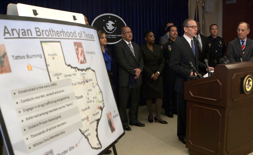 Assistant Attorney General Lanny Breuer speaks at the U.S. attorney's office in Houston on Nov. 9, 2012. Officials announced the arrest of dozens of Texas members of the white supremacist Aryan Brotherhood gang on federal racketeering charges for crimes including murder, kidnapping, arson, gambling and trafficking in methamphetamine and cocaine.