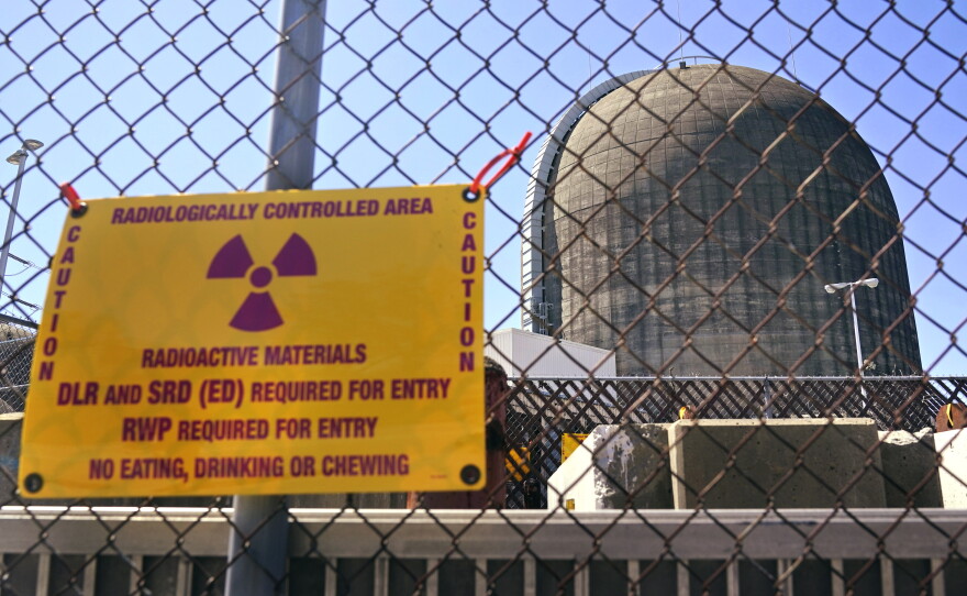 A sign warning of radioactive materials is seen on a fence outside Indian Point Energy Center in Buchanan, N.Y. just days before it closed in 2021. The Trump administration is seeking to overhaul nuclear safety rules to aid a nuclear revival.