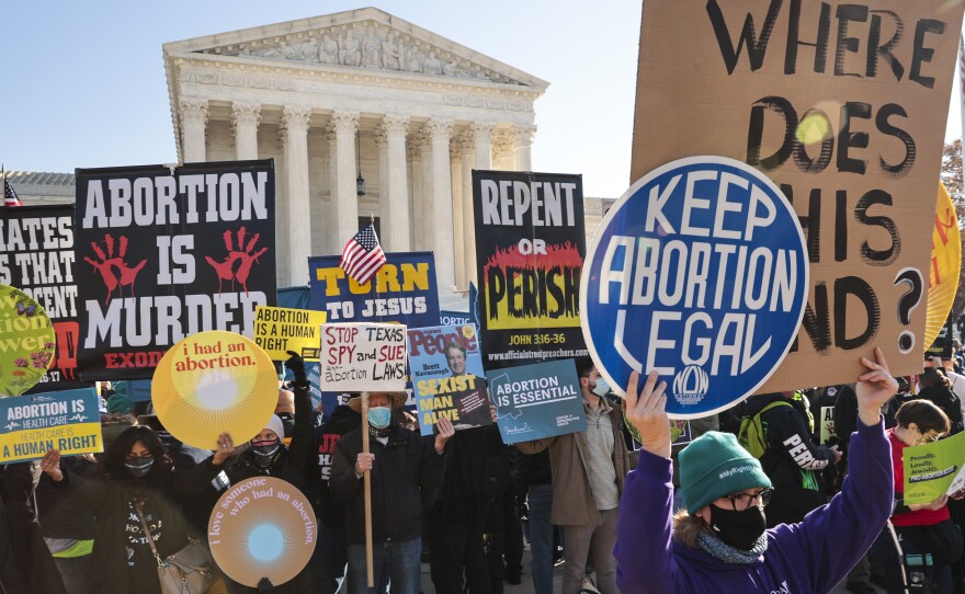 Demonstrators gather in front of the U.S. Supreme Court as the justices hear arguments in Dobbs v. Jackson Women's Health case in 2021.