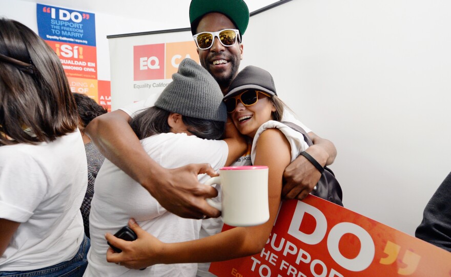 Brandon Benoit, Martha Acevedo (left) and Briana Castaneda celebrate the Supreme Court rulings at Equality California, a nonprofit civil rights organization that advocates for the rights of LGBT people.