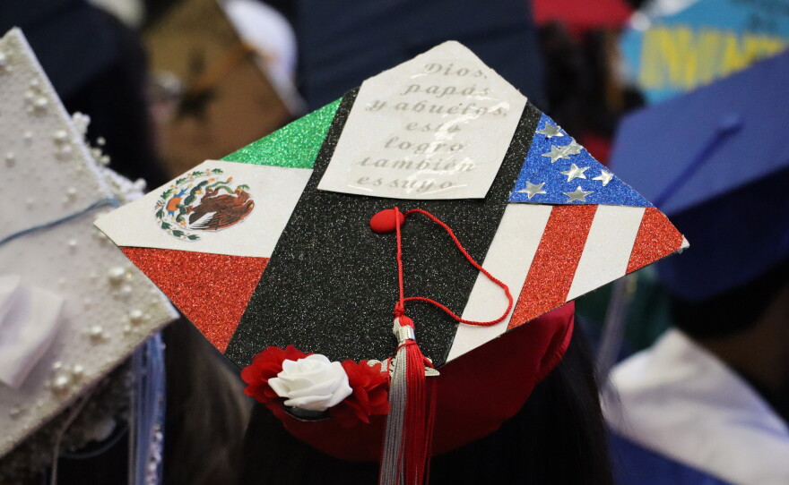 A student's graduation cap reads "God, parents and grandparents, this accomplishment is also yours" on Tuesday, June 9, 2026.