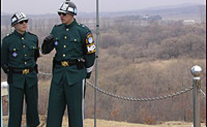 South Korean soldiers stand guard on the border. The treeline behind them is where North Korean soil begins.  The haze is from spring sand arriving from the Gobi desert. Observers say talks on North Korea's nuclear future "are in a fog of yellow sand."