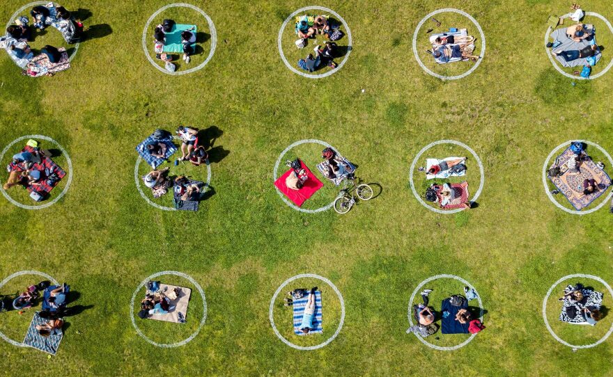 An aerial view shows people gathered in painted circles on the grass encouraging social distancing last week at Dolores Park in San Francisco.