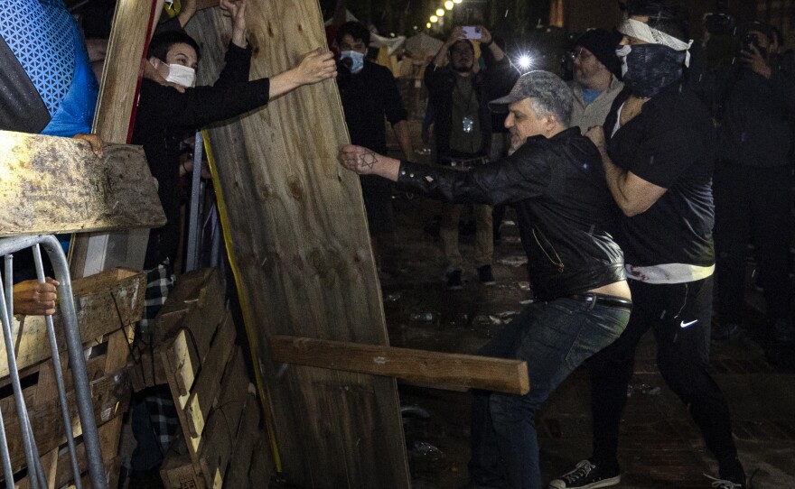 Counterprotesters try to dismantle a pro-Palestinian encampment set up on the University of California, Los Angeles campus in the early hours of Wednesday.