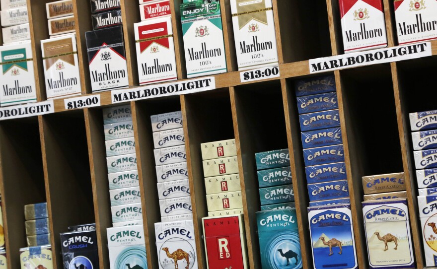 Cigarette packs are displayed at a convenience store in New York City, which has raised the age to buy cigarettes from 18 to 21.