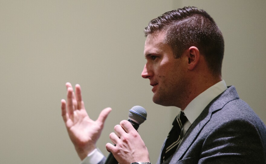 Richard Spencer addresses a room of press and conference attendees at a news conference held by the National Policy Institute during its "Become Who We Are" event in Washington, D.C. Prior to the news conference, which was held in the same room as the broader NPI event, Spencer told journalists they could not take photos of the room because attendees could be identified without their permission.