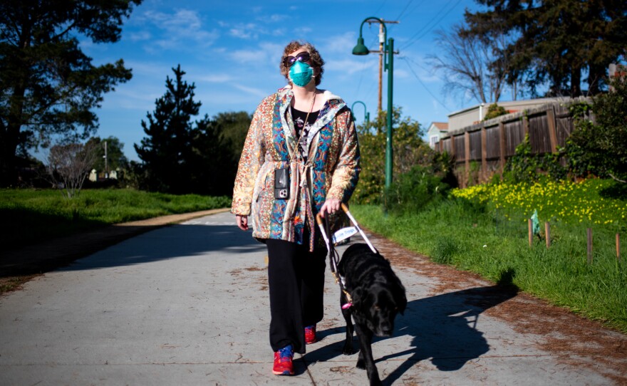 Sassy Outwater-Wright walks through her neighborhood with her guide dog Ferdinand in Berkeley on Jan. 20, 2022.