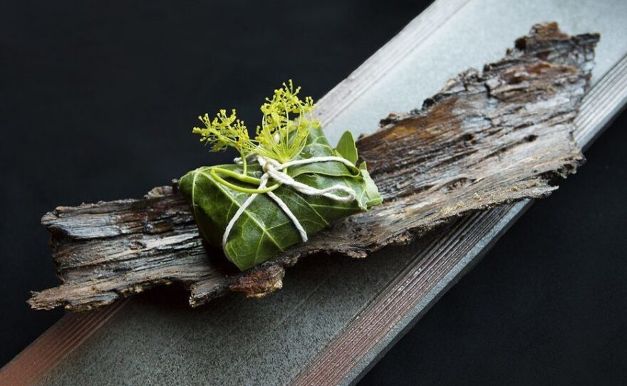 Greens served on a plate made of bark at N/Naka.