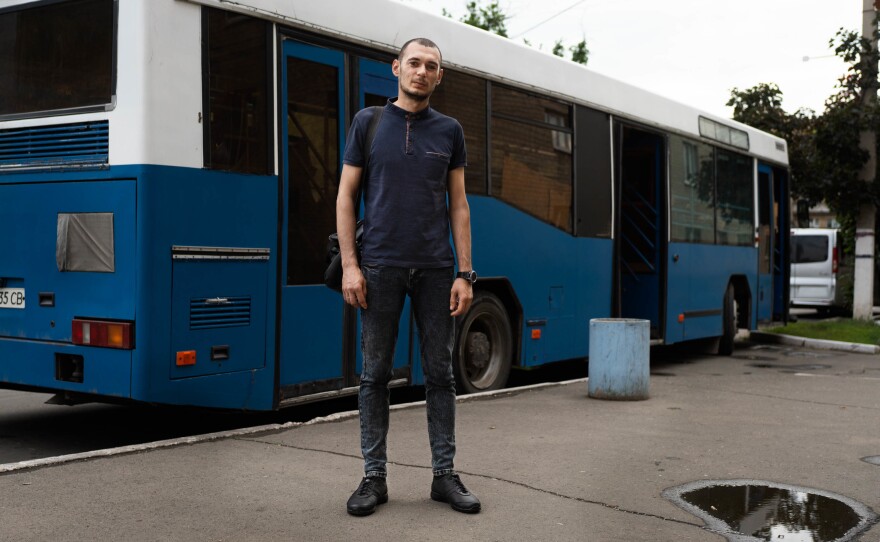 Valerie Ivaniv stands at a bus station in Pokrovsk, near the front lines and the Russian-backed separatist Donetsk region, where he waits for a bus to pick him up for a 12-hour shift at the mine.