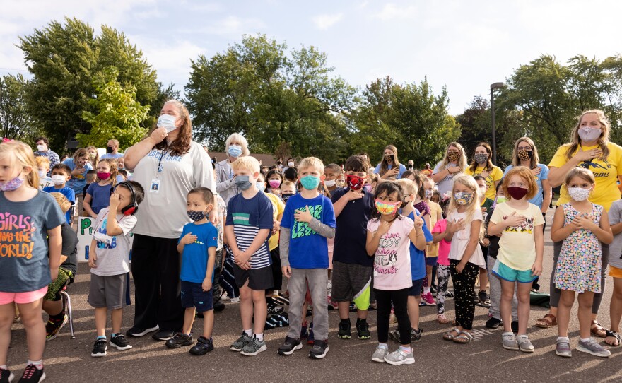 Students and staff recite the Pledge of Allegiance before Monday's pep rally at Locust Lane Elementary School.