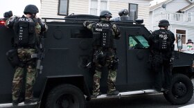 A Seattle police SWAT vehicle on Monday leaves the scene of a search for Maurice Clemmons, who was shot and killed by police early Tuesday in a south Seattle neighborhood.