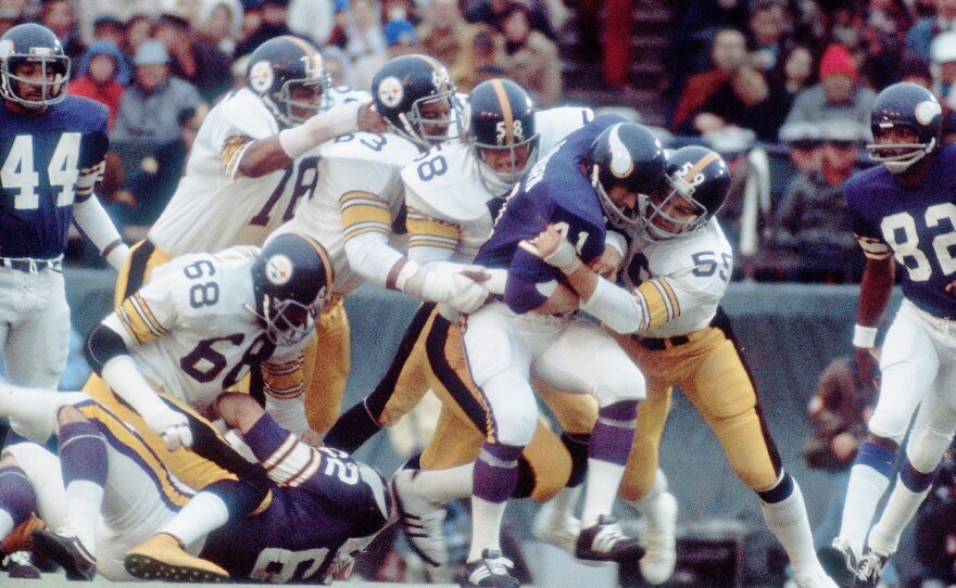 Pittsburgh Steelers defense (from left) Dwight White, Ernie Holmes,  Jack Lambert and Jack Ham tackle Minnesota Vikings Dave Osborn during Super Bowl IX in New Orleans in 1975. The Steelers won 16-6.
