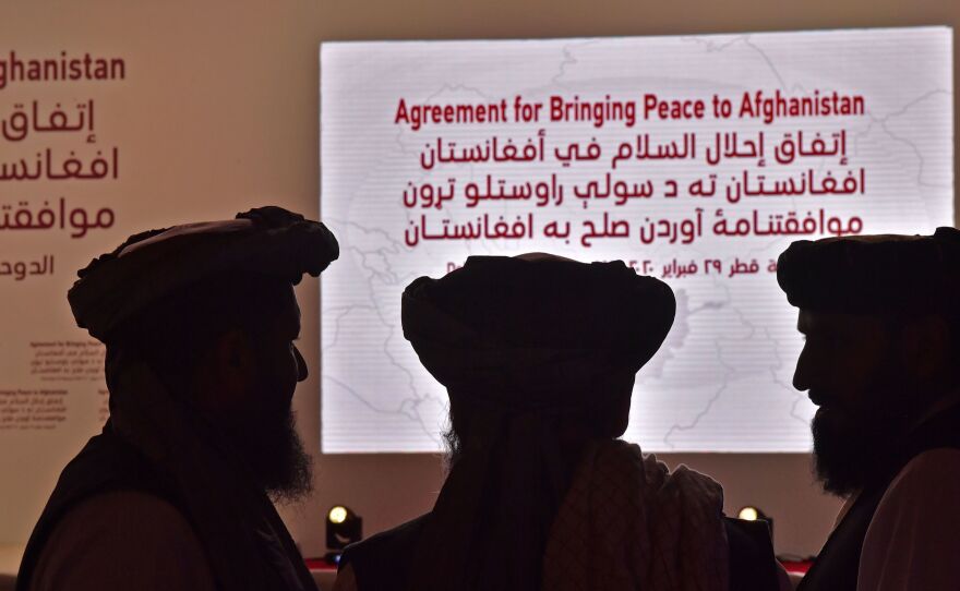 Members of the Taliban delegation gather ahead of Saturday's signing ceremony with the United States in the Qatari capital of Doha.