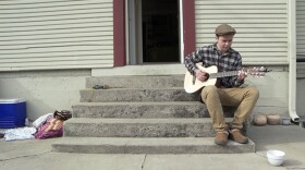 Bennett plays guitar on the porch.