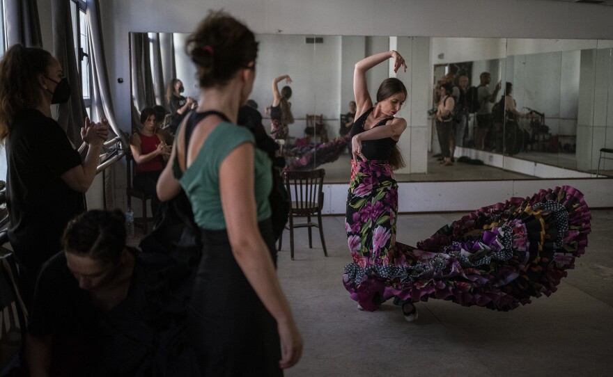 Student at Amor de Dios performs a number with a <em>bata de cola</em>.
