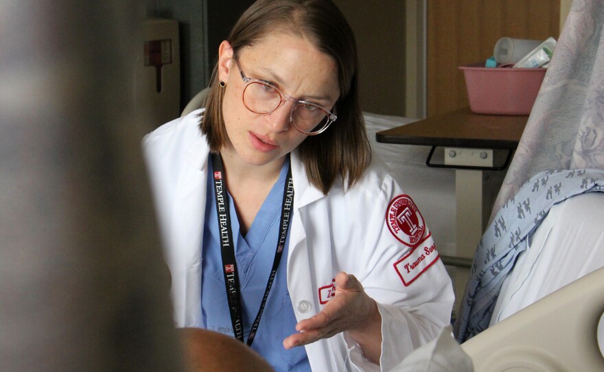 Dr. Zoe Maher interviews a shooting victim at Temple University Hospital for a citywide study of care of violent trauma victims.