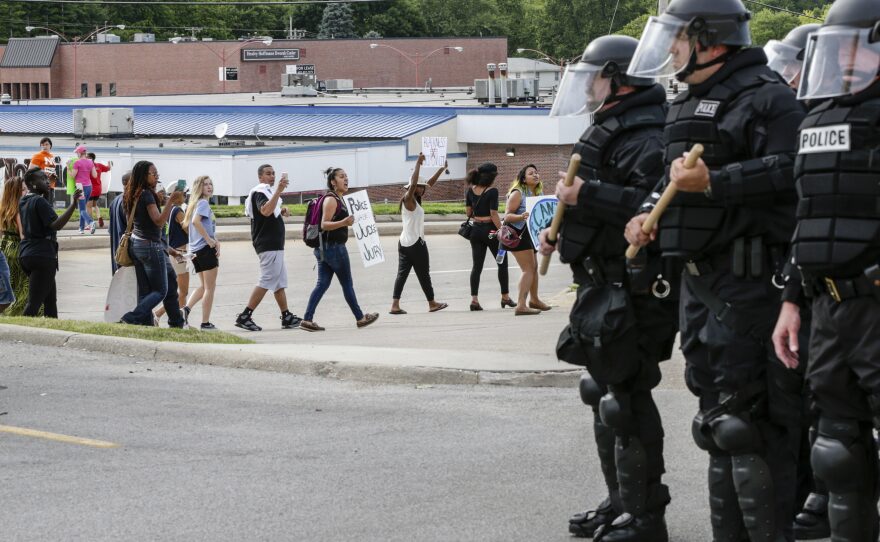 Police forces in riot gear keep watch on a demonstration in Omaha, Neb., on July 8. Participants were protesting the recent shooting death by police of Alton Sterling and Philando Castile.