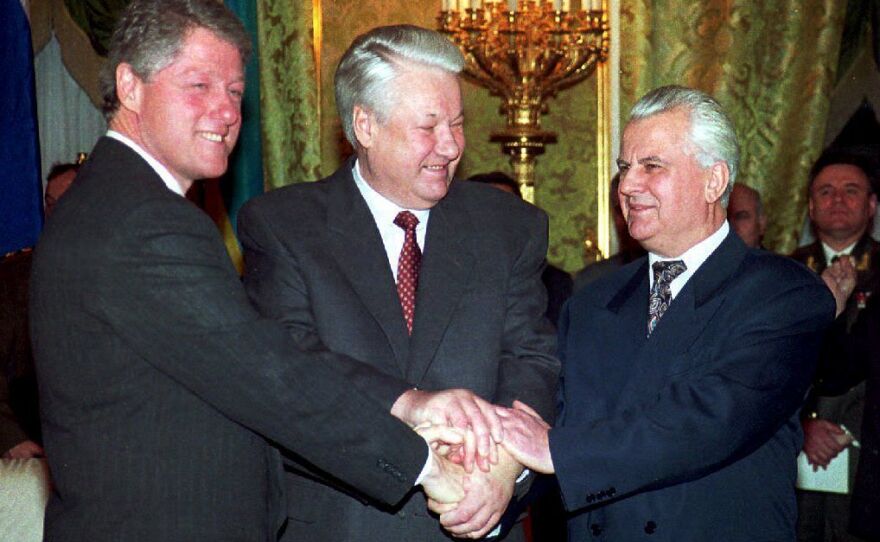 President Bill Clinton (from left), Russian President Boris Yeltsin and Ukrainian President Leonid Kravchuk join hands On Jan. 14, 1994, after signing a nuclear disarmament agreement in the Kremlin. Under the agreement Ukraine, the world's third-largest nuclear power, said it would turn all of its strategic nuclear arms over to Russia for destruction.