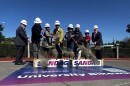 Officials toss dirt with shovels as part of a ceremonial groundbreaking on the University Bikeway, March 11, 2026.