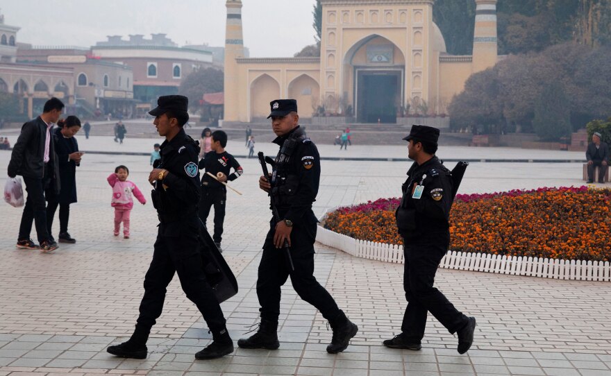 Uighur security personnel patrol near the Id Kah Mosque in Kashgar, a city in northwestern China's Xinjiang region, in 2017. Xinjiang has detained members of the Uighur ethnic minority, who are largely Muslim, and held them in camps the authorities call "education and training centers."