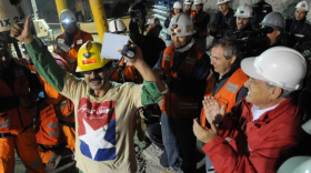 Chile's President Sebastian Pinera, front right, hugs rescued miner Florencio Avalos after Avalos was rescued from the collapsed San Jose gold and copper mine where he was trapped with 32 other miners for over two months near Copiapo, Chile.