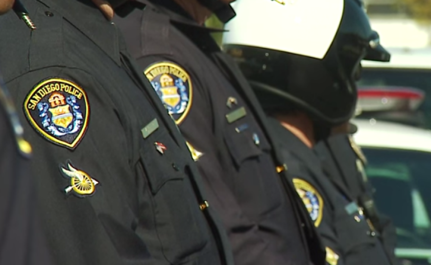 San Diego police officers stand in a line revealing a patch on the right shoulder of their uniforms in this undated photo. 