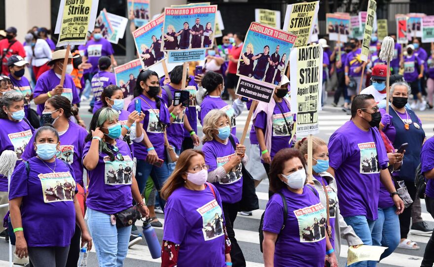 More than 1,000 janitors with the Service Employees International Union rally and march as their contracts expire ahead of a potential strike on Sept. 1, 2021, in Los Angeles.