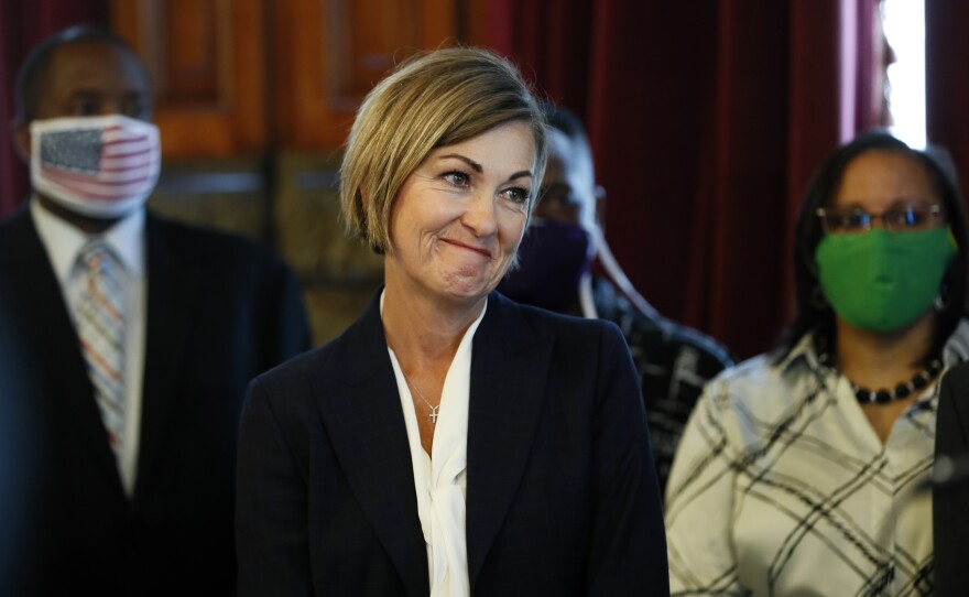 Iowa Gov. Kim Reynolds looks on after signing an executive order granting convicted felons the right to vote during a signing ceremony at the Statehouse in Des Moines, Iowa.