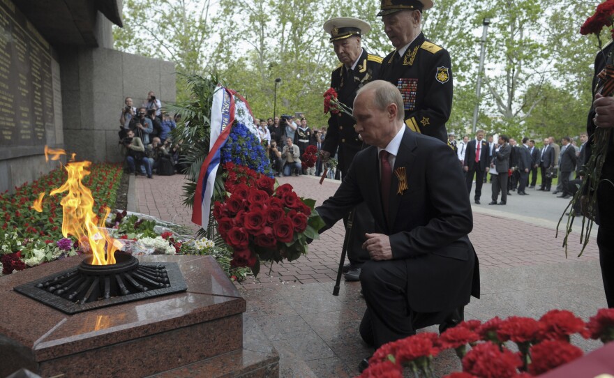 President Vladimir Putin lays flowers during a ceremony marking Victory Day in the Crimean city of Sevastopol Friday. It was his first visit to the region since Russia annexed it in March.