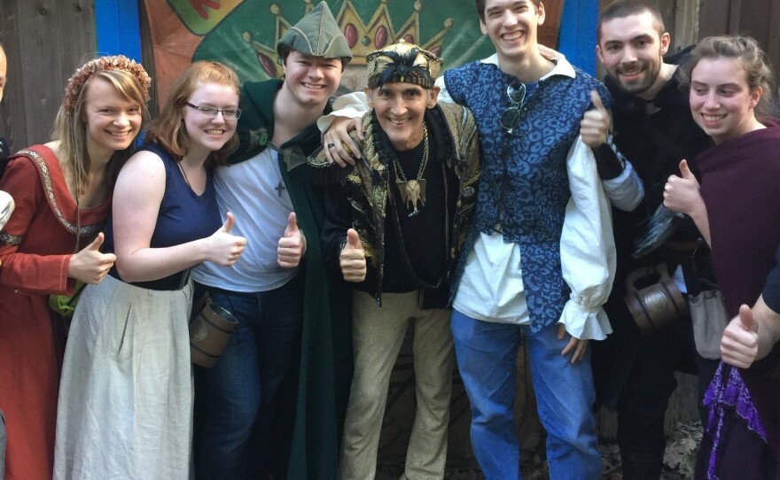 Johnny Fox, middle, gives a thumbs up with fans at the Maryland Renaissance Festival.