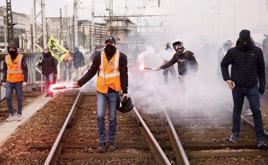 Railway workers demonstrate on the tracks at the Gare de Lyon train station on Tuesday in Paris. A new round of strikes and demonstrations is planned against the unpopular pension reforms that, most notably, push the legal retirement age from 62 to 64.