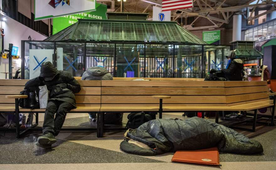 Homeless people stay warm at South Station, set up as as warming center, as temperatures reached minus 7 Fahrenheit in Boston on Saturday.