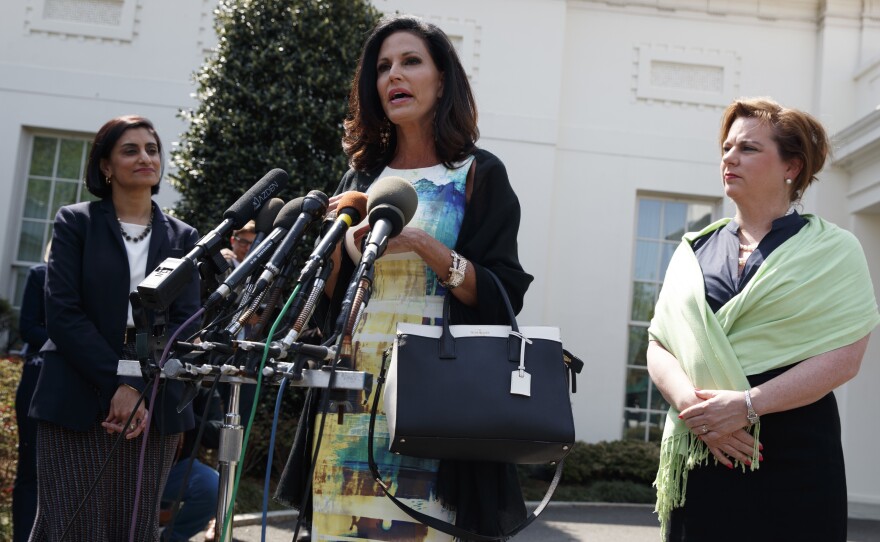 Marjorie Dannenfelser, president of the Susan B. Anthony List (right) and Seema Verma (left), administrator of the Centers for Medicare and Medicaid Services, look on as Concerned Women for America CEO Penny Nance speaks with reporters outside the White House on Thursday.