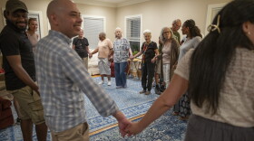Former residents, current residents and friends of Anne Montgomery House begin a traditional Greek dance at the farewell celebration in Washington, D.C. on July 31, 2026. The community house, run by Society of the Sacred Heart, is closing after a decade.