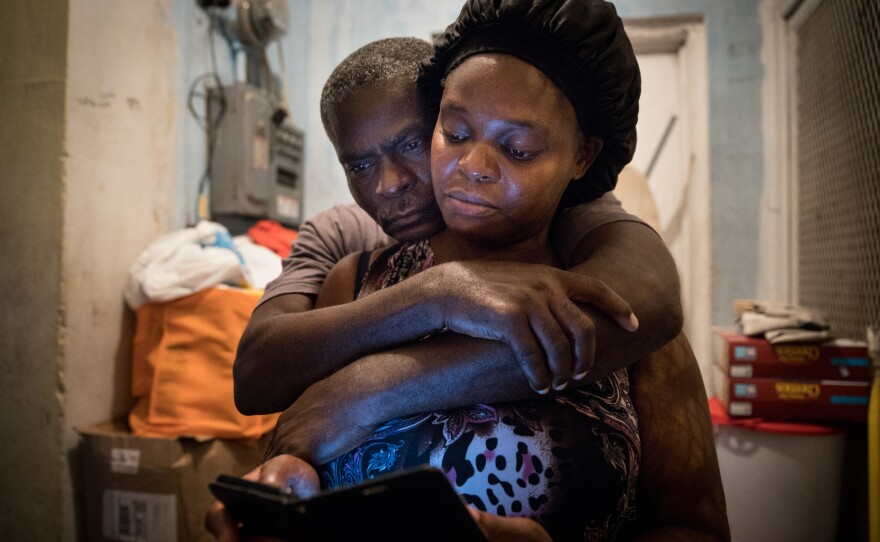 A month after Hurricane Dorian devastated the Bahamas, Sherrine Petit Homme LaFrance gets a hug from husband Ferrier Petit Homme. The storm destroyed their home on Grand Abaco Island. They are now living with China Laguerre in Nassau.