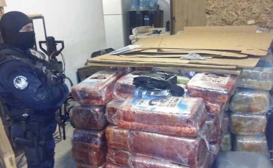 A Mexican law enforcement officer is pictured with 12 tons of marijuana found in a drug tunnel between Tijuana and Otay Mesa Oct. 22, 2015.