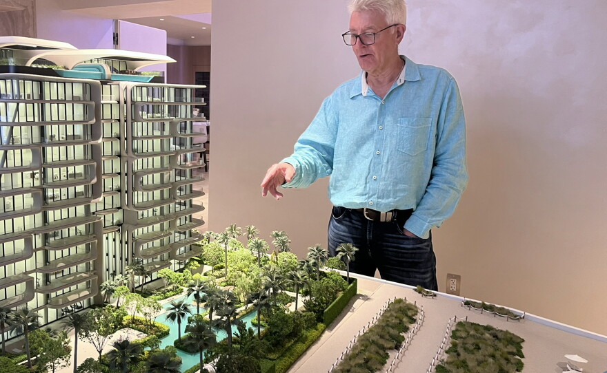 Jeffery Rossely, a developer at the Dubai-based firm Damac Properties, points to a model of a luxury property called The Delmore.