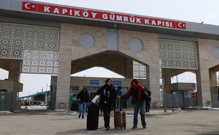 People at the Kapikoy border crossing between Turkey and Iran, in eastern Van province, Turkey, March 2.