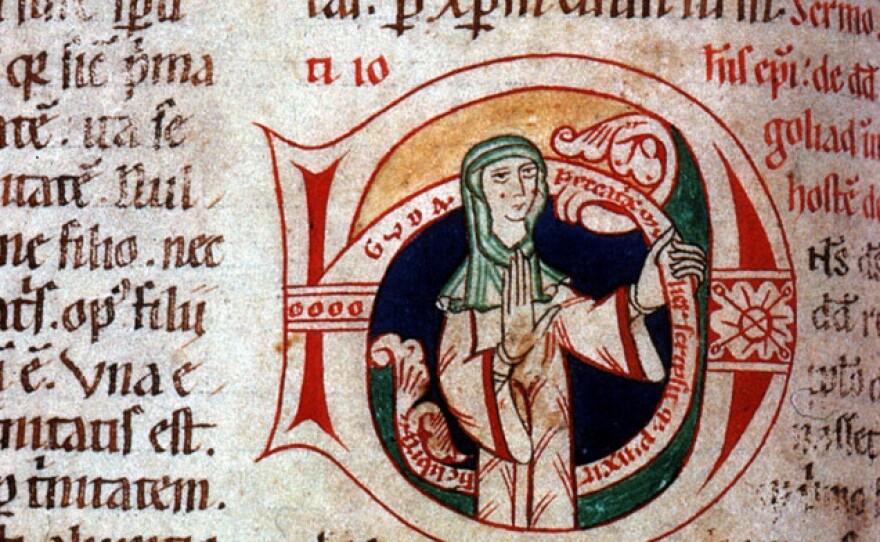 This image shows Guda, a 12th century nun, and the inscription reads, "Guda, a sinful woman, wrote and painted this book." It's a rare example of a manuscript signed by a female scribe.
