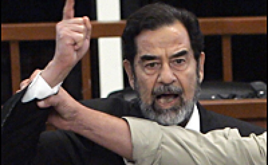 Saddam Hussein yells at the court as he receives his death sentence.